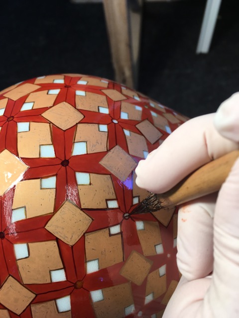 Hand Painting gold line on Luminosity Vase. This piece required 7 firings.